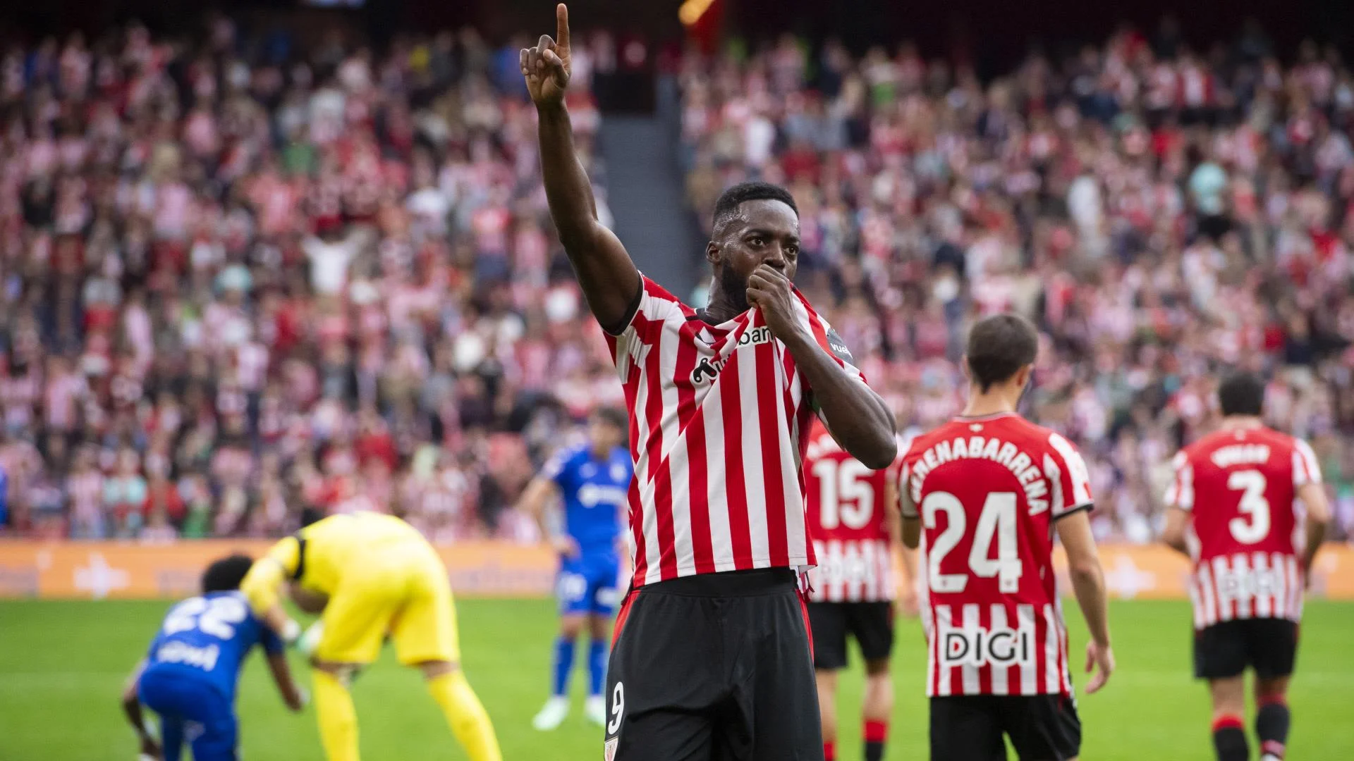 Athletic Club striker Iñaki Williams, in Athletic's red-and-white striped home shirt, points to the sky while celebrating at San Mamés during the 4-0 win over Getafe on 25 October 2026, with team-mate Beñat Gerenabarrena (No 24) behind him. Photo: Athletic Club