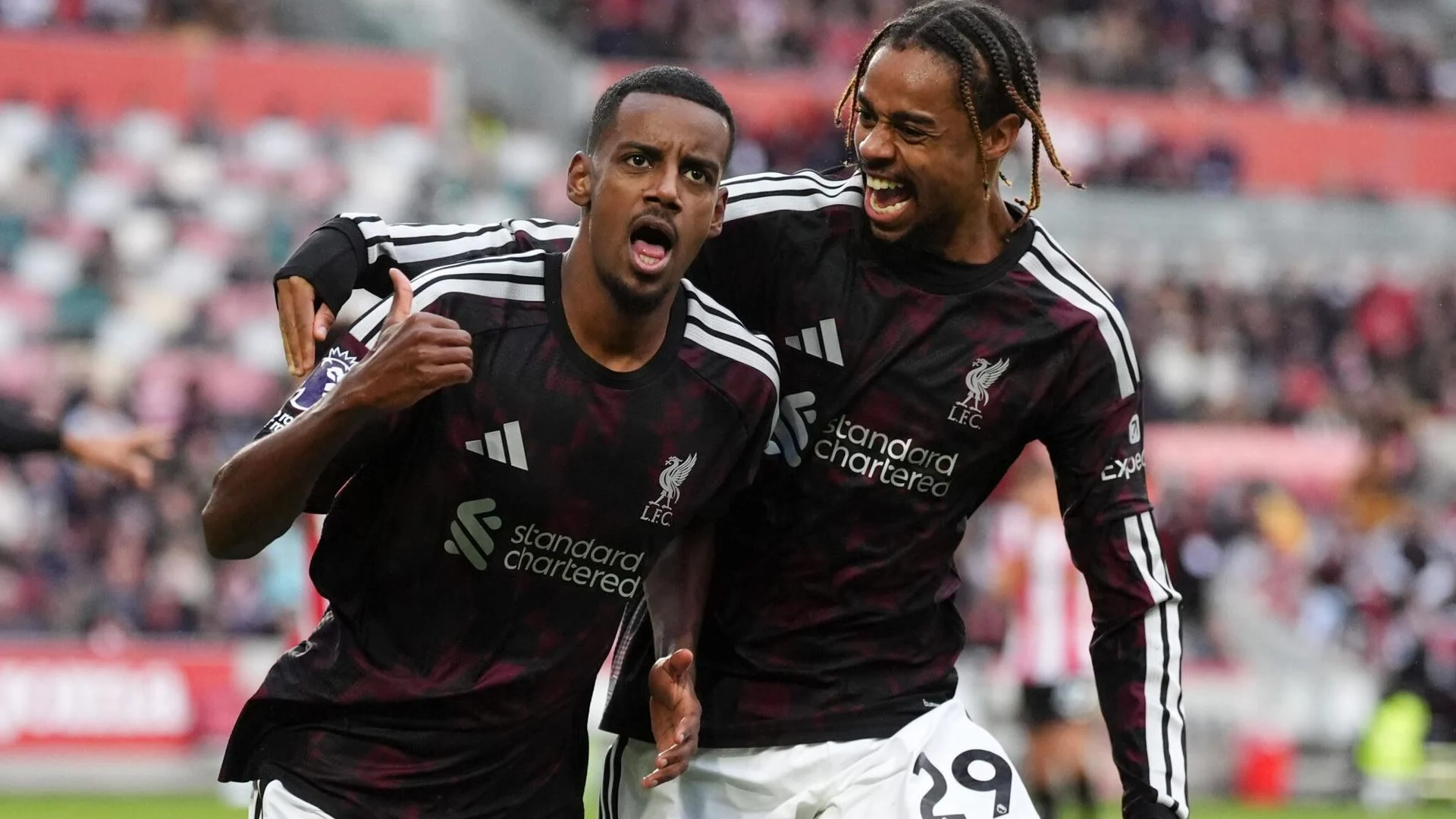 Alexander Isak shouts in celebration as Bradley Barcola, wearing No 29, wraps an arm around him, both in Liverpool's dark red and black away kit, after Isak's goal against Brentford at the Gtech Community Stadium. Photo: Sky Sports