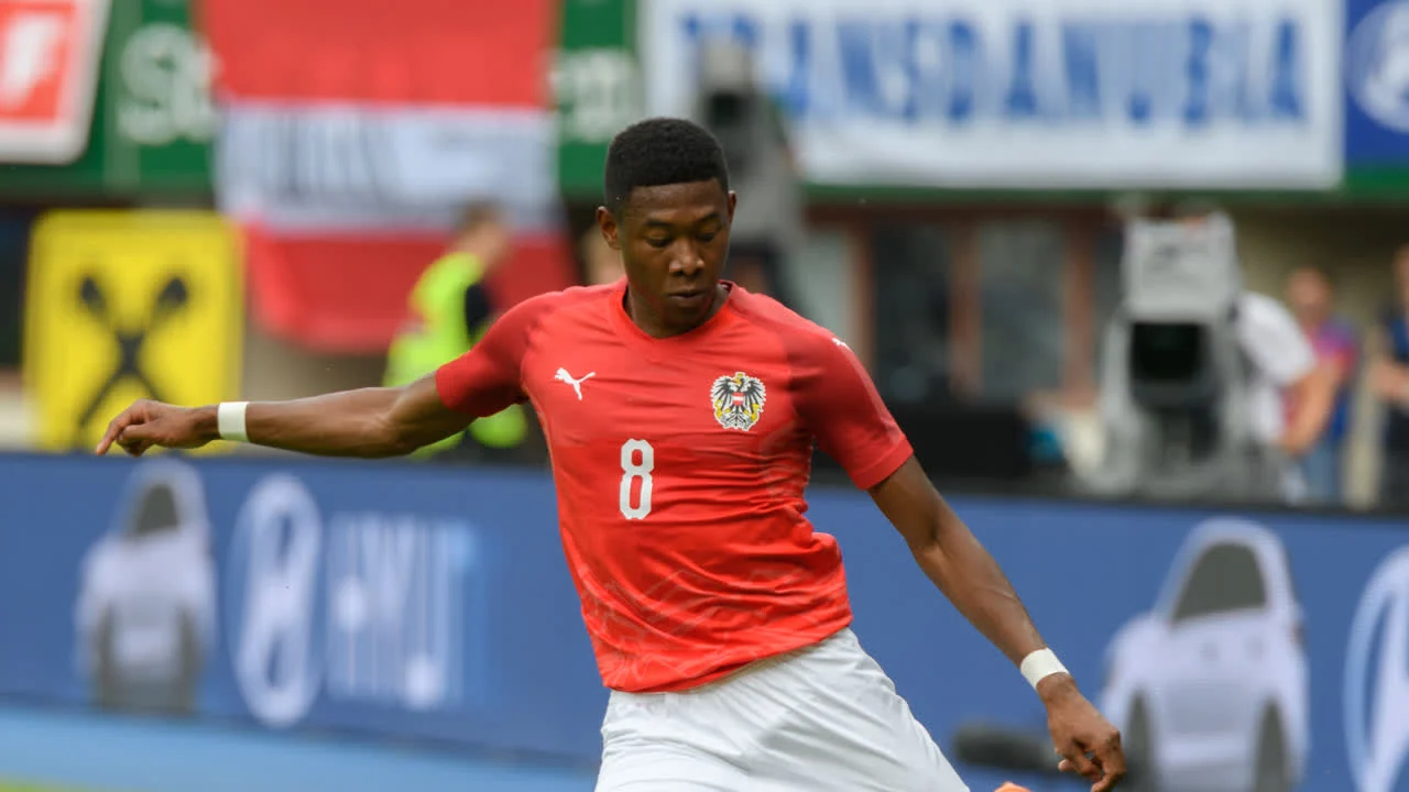 David Alaba celebrating in a white Real Madrid kit with a gold medal after the 2023 Copa del Rey final