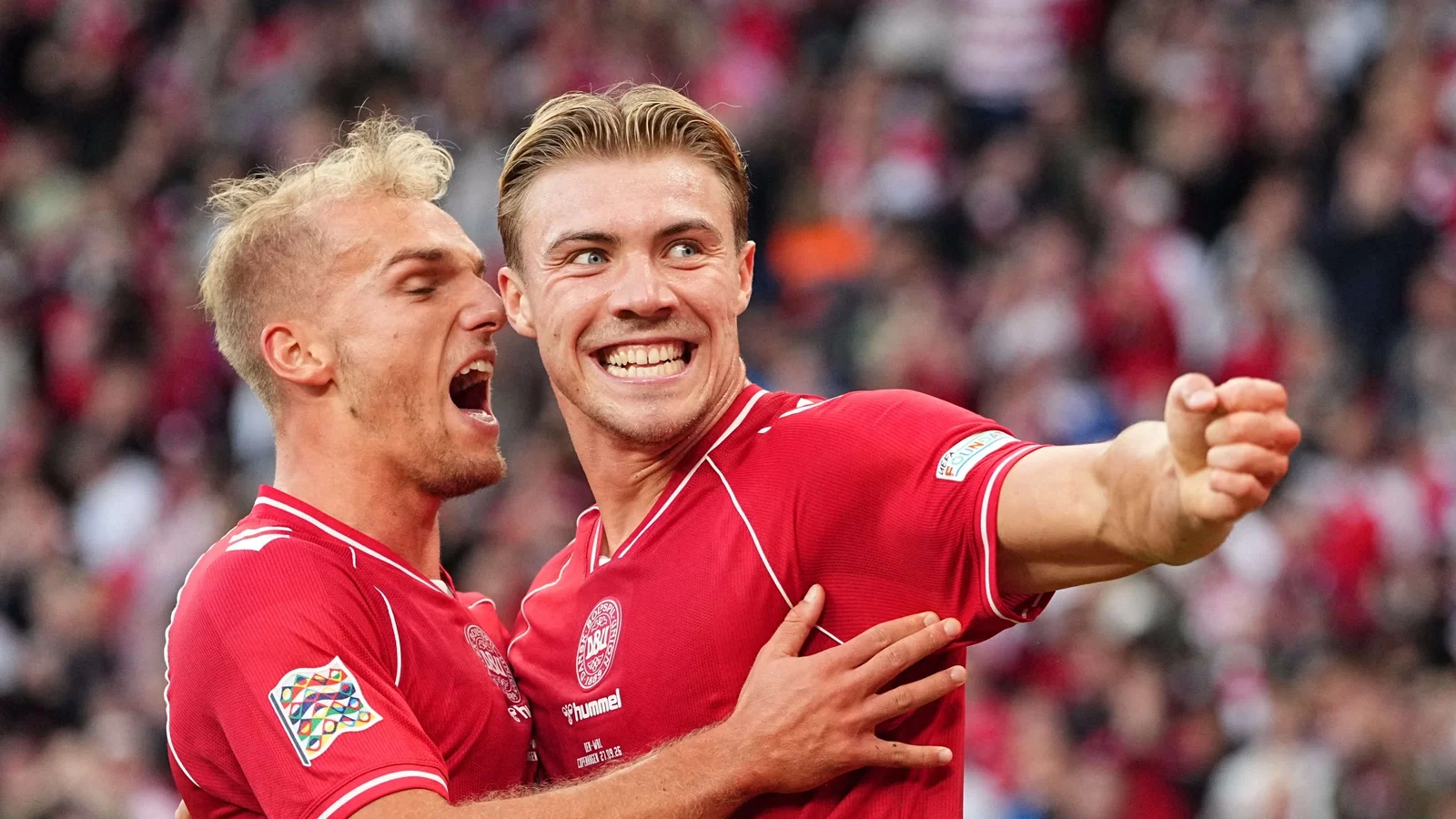 Gustav Isaksen and Rasmus Højlund celebrate in Denmark shirts during the Nations League win over Wales