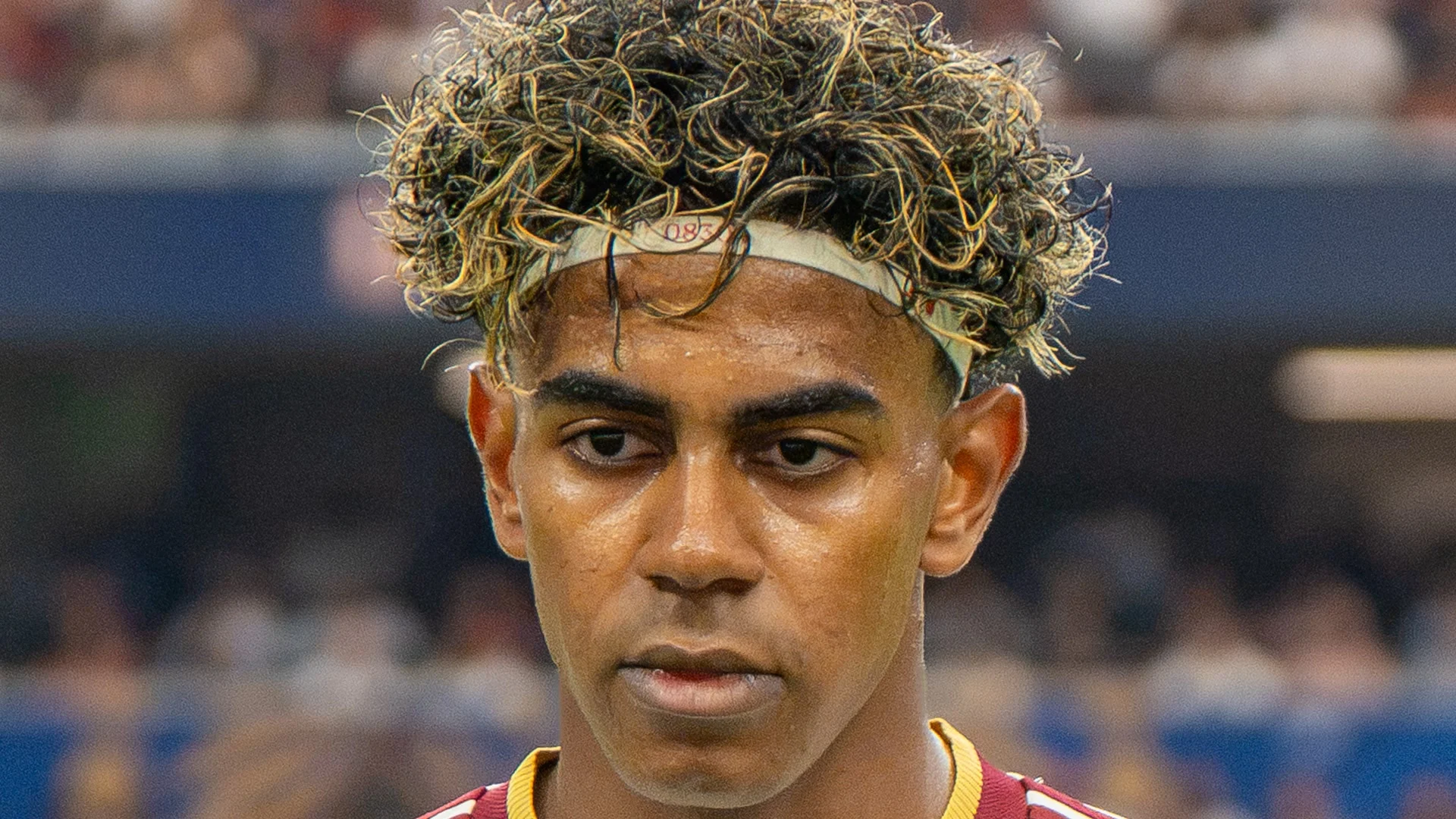 Lamine Yamal in a maroon Spain jersey with a white headband during France v Spain at the 2026 FIFA World Cup