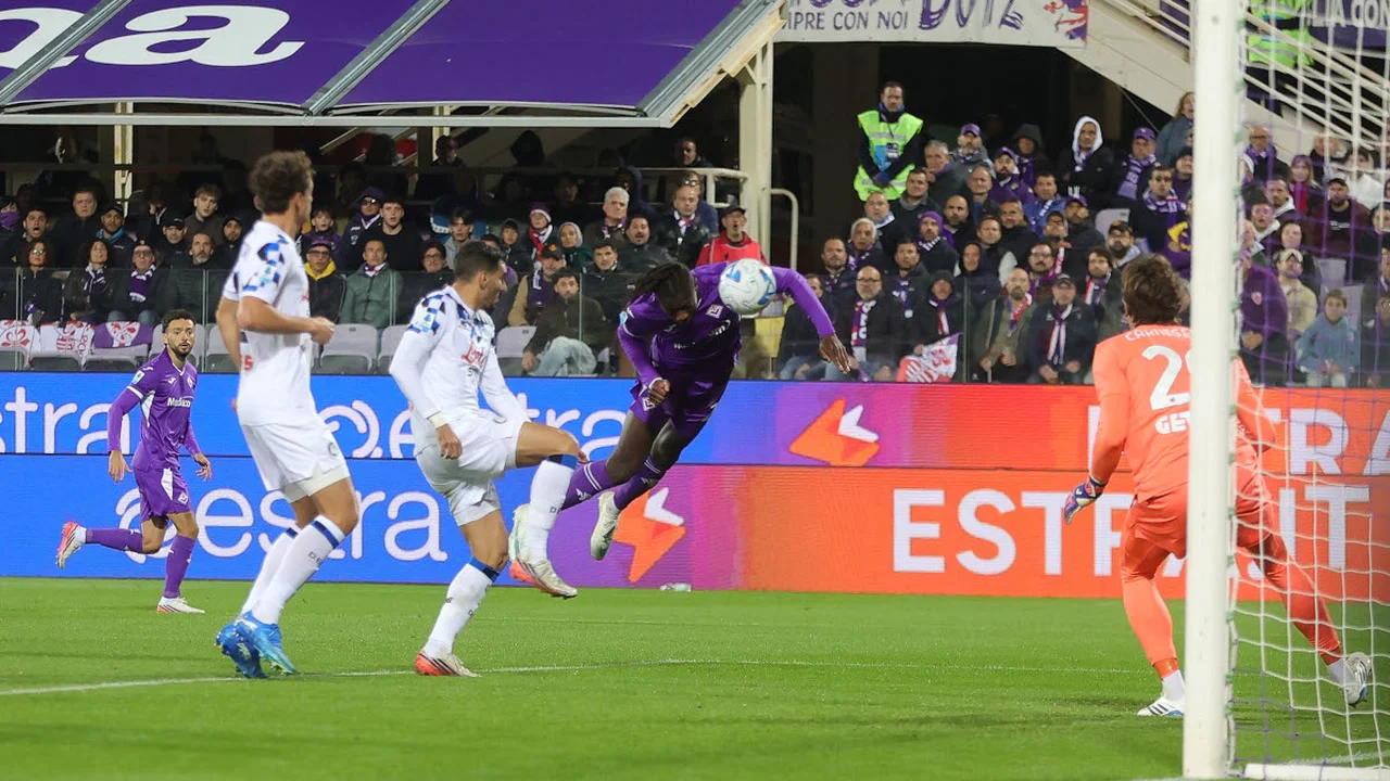 Alieu Njie of Fiorentina scores with a diving header against Atalanta at the Stadio Artemio Franchi