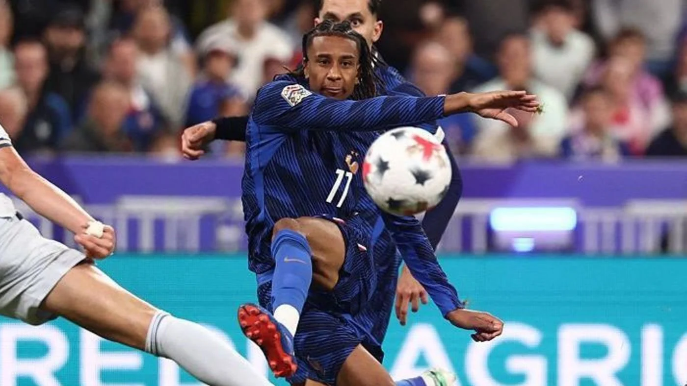 Michael Olise, in France's navy number 11 shirt, strikes the ball against Italy at the Stade de France (Photo: BBC Sport (match page image, photographer not named))