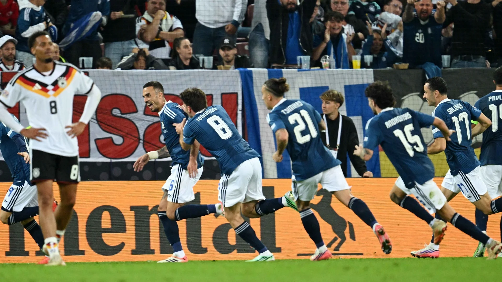 Greece's Dimitrios Kourbelis celebrates his goal with teammates in Greece's blue kit at the WWK Arena. Photo: Angelika Warmuth / Reuters