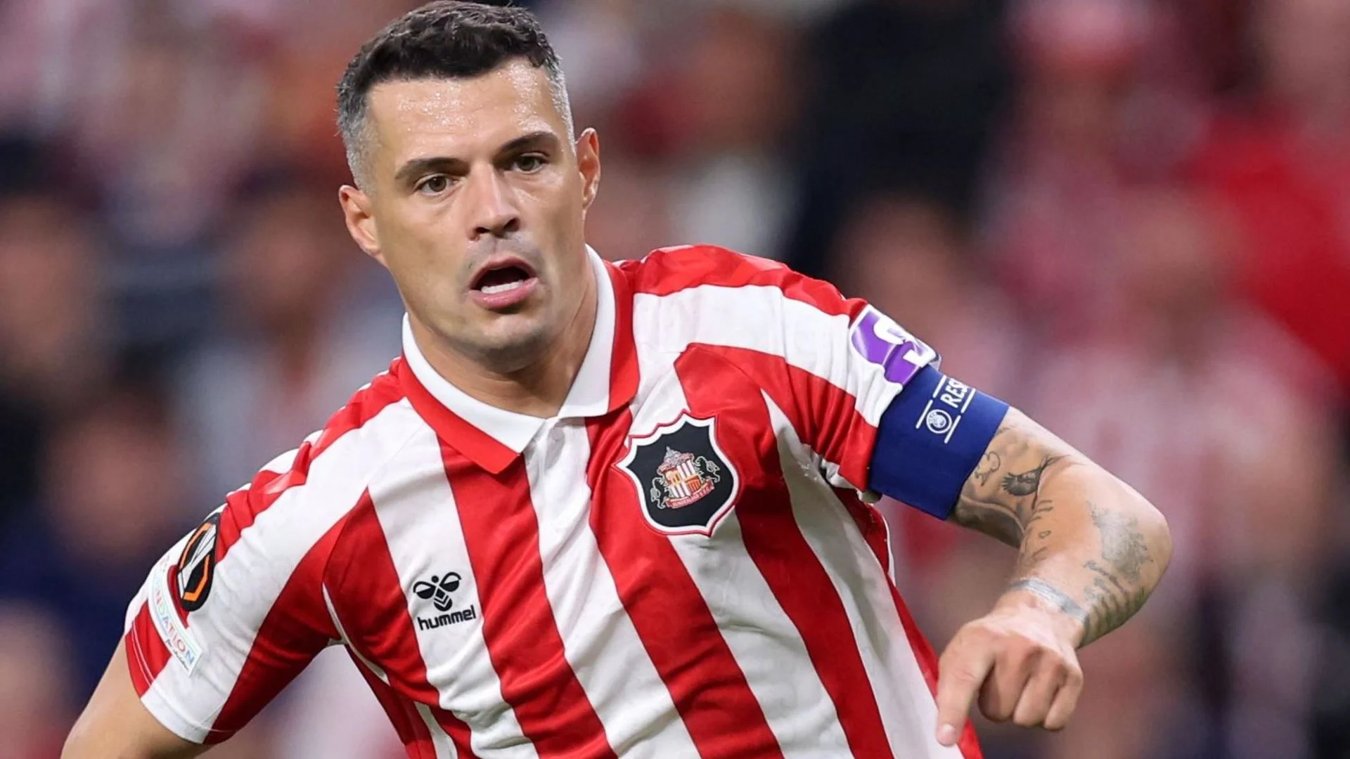 Granit Xhaka in Sunderland's red and white striped shirt and captain's armband during a match