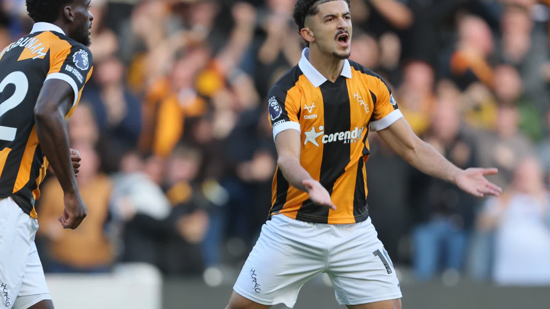 Mohamed Belloumi in a Hull City amber and black striped kit reacting during a Premier League match
