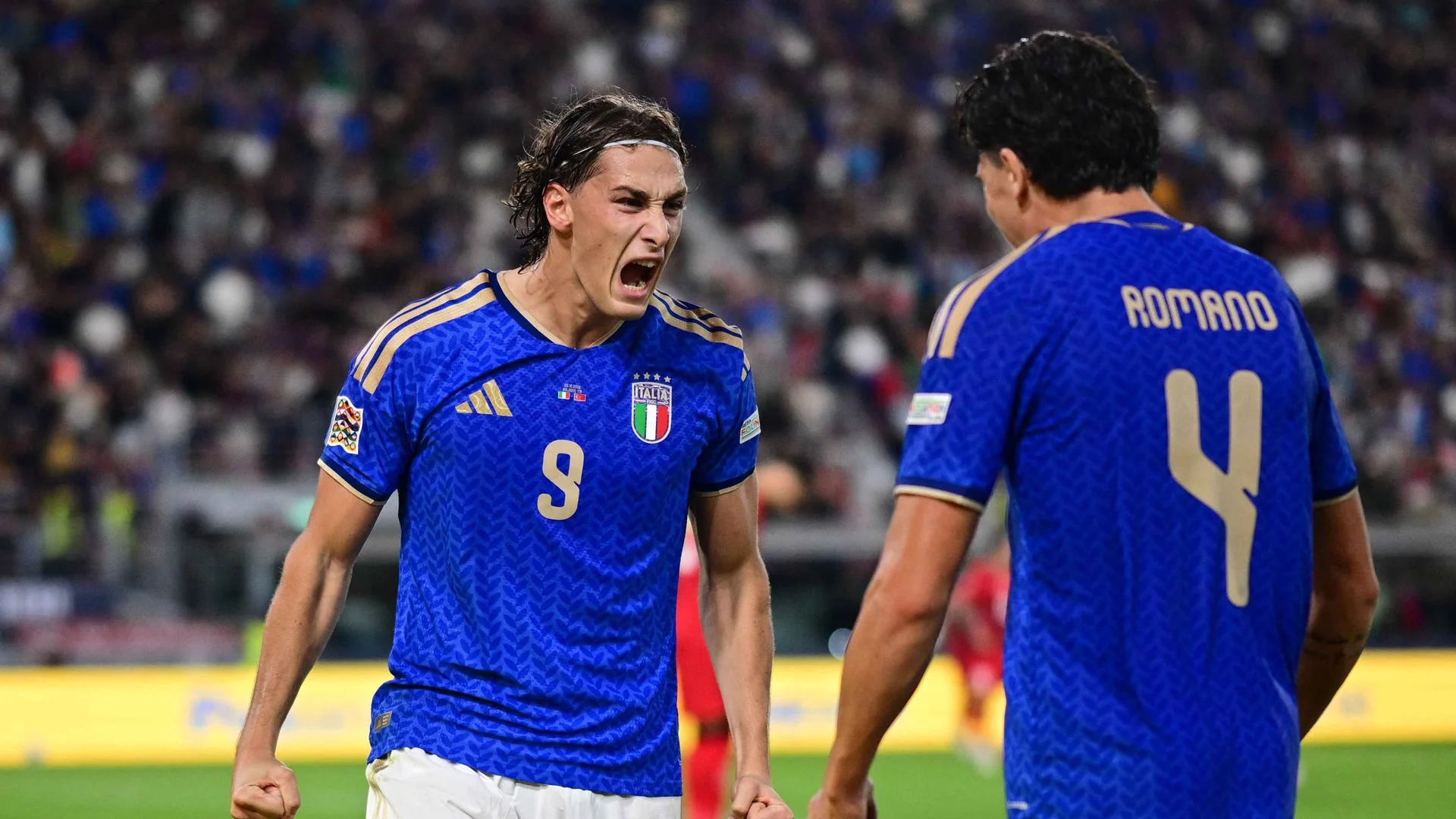 Pio Esposito, in Italy's blue number 9 shirt, roars in celebration towards team-mate Alessandro Romano after scoring Italy's third goal against Türkiye in Bologna (Photo: Reuters/Daniele Mascolo via Flashscore)