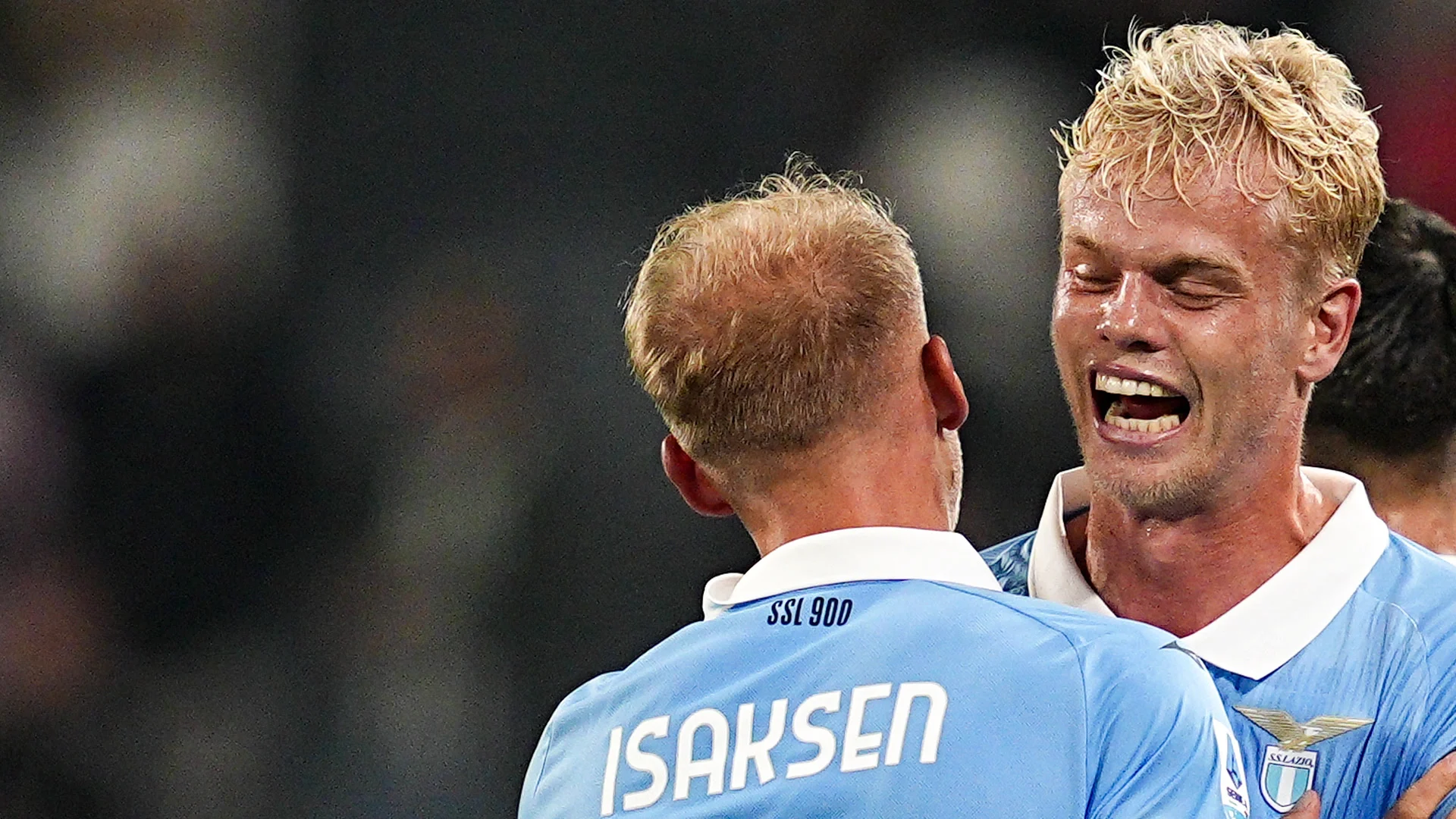Lazio's Gustav Isaksen (No 11, seen from behind with his name on his sky-blue shirt) embraces a blond Lazio team-mate who is shouting in celebration during Lazio's 3-0 Serie A win at Juventus at the Allianz Stadium. Photo: Marco Alpozzi/LaPresse