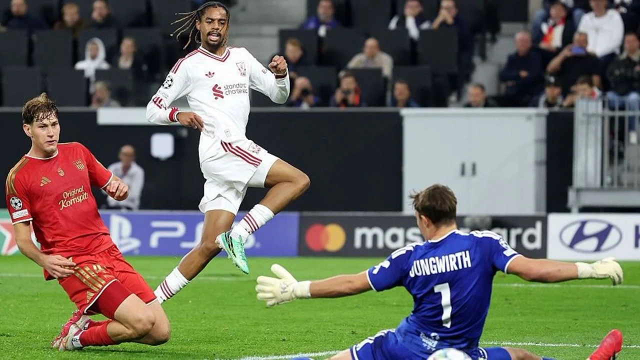 Bradley Barcola in Liverpool's white kit shoots past diving LASK goalkeeper Lukas Jungwirth at the Raiffeisen Arena in Linz. Photo: BBC Sport