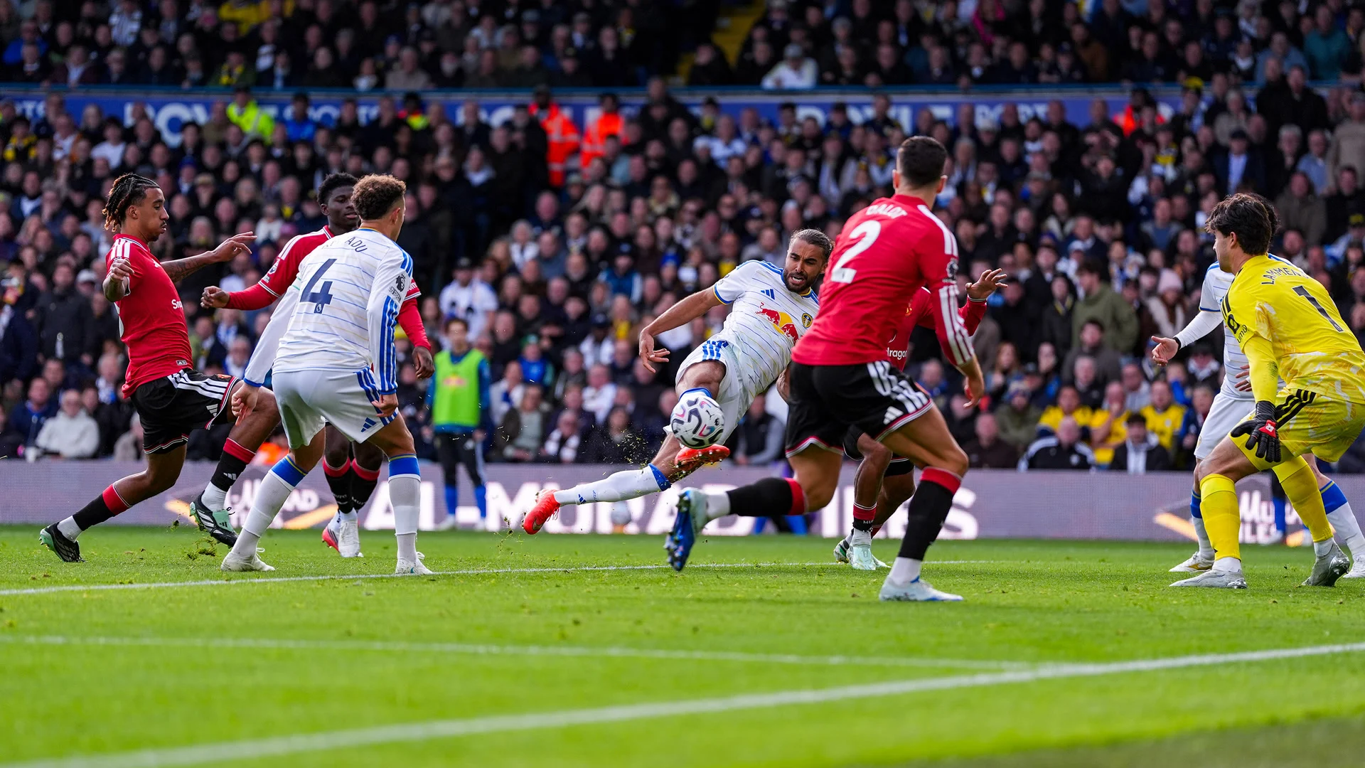 Dominic Calvert-Lewin, in Leeds United's white kit, stretches to strike the ball for his equaliser against Manchester United at Elland Road as Diogo Dalot and goalkeeper Senne Lammens close in. Photo: Leeds United