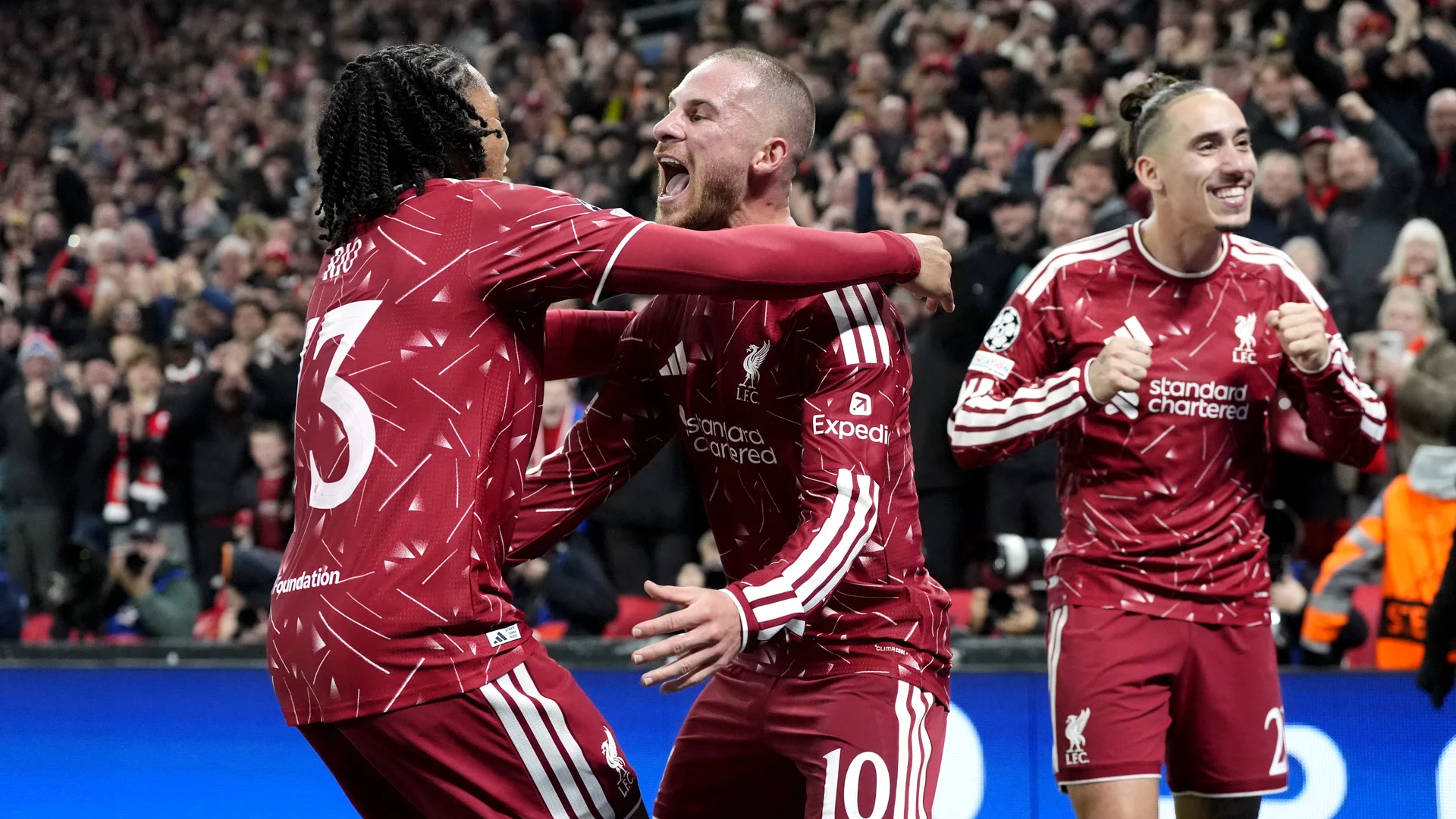 Alexis Mac Allister, in Liverpool's red home kit with the number 10, celebrates with Rio Ngumoha (number 73) and a teammate in front of the Anfield crowd during Liverpool's 4-3 Champions League win over Villarreal. Photo: Nick Potts / PA Images via Getty Images