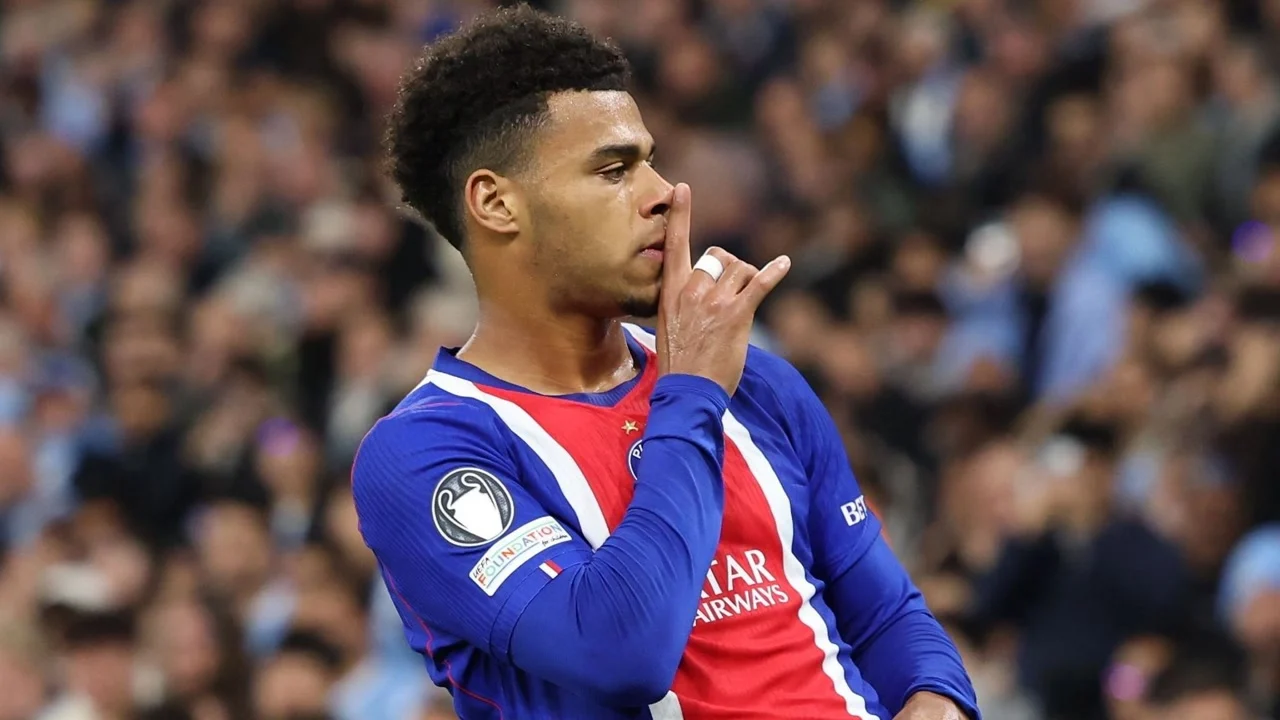 Désiré Doué in Paris Saint-Germain's blue and red kit puts a finger to his lips after scoring against Manchester City at the Etihad Stadium. Photo: EPA via BBC Sport