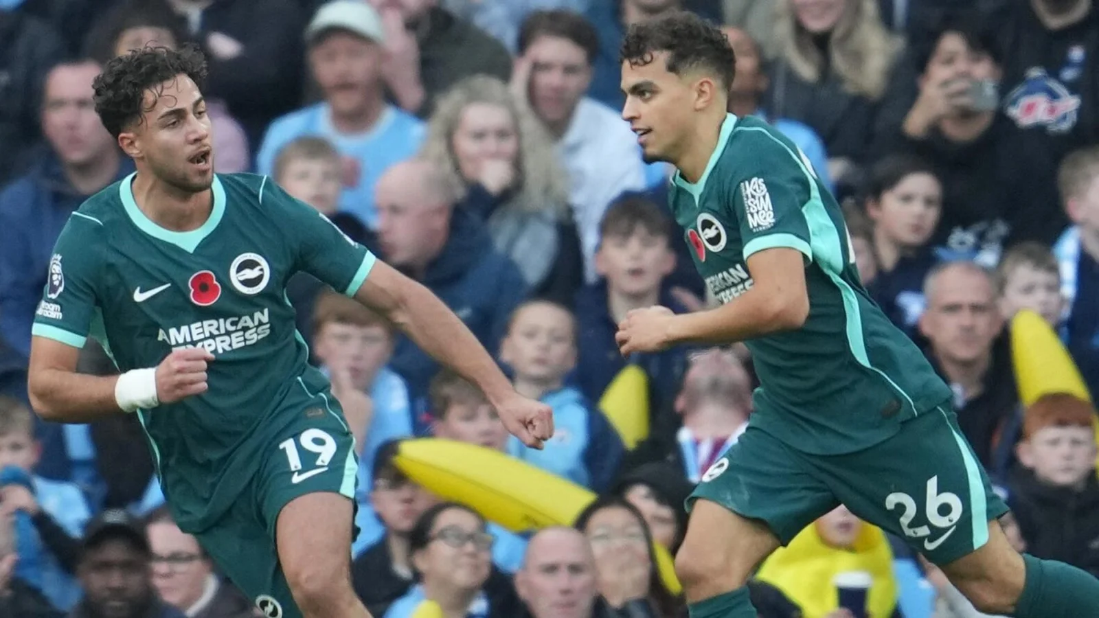 Yasin Ayari and Charalampos Kostoulas celebrate in Brighton's green away kit after Ayari's goal against Manchester City at the Etihad Stadium
