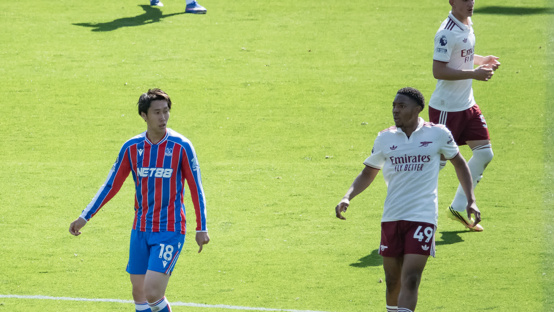 Daichi Kamada in a Crystal Palace red and blue striped kit on the pitch