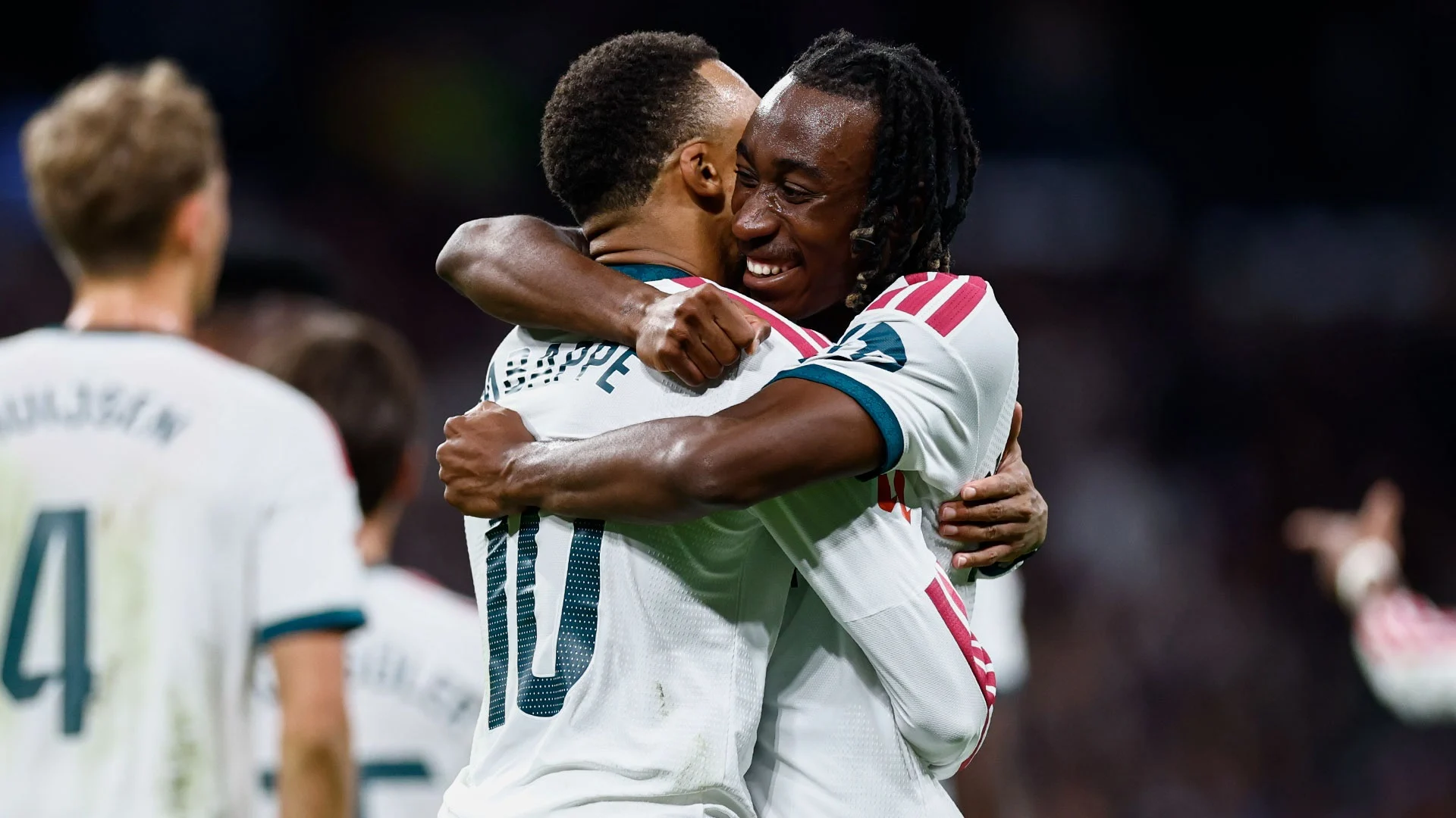 Kylian Mbappé (No 10, back to camera) hugs a smiling Yan Diomande, both in Real Madrid's white home kit, during the 4-1 La Liga win over Sevilla at the Bernabéu, with Dean Huijsen (No 4) blurred on the left. Photo: Real Madrid