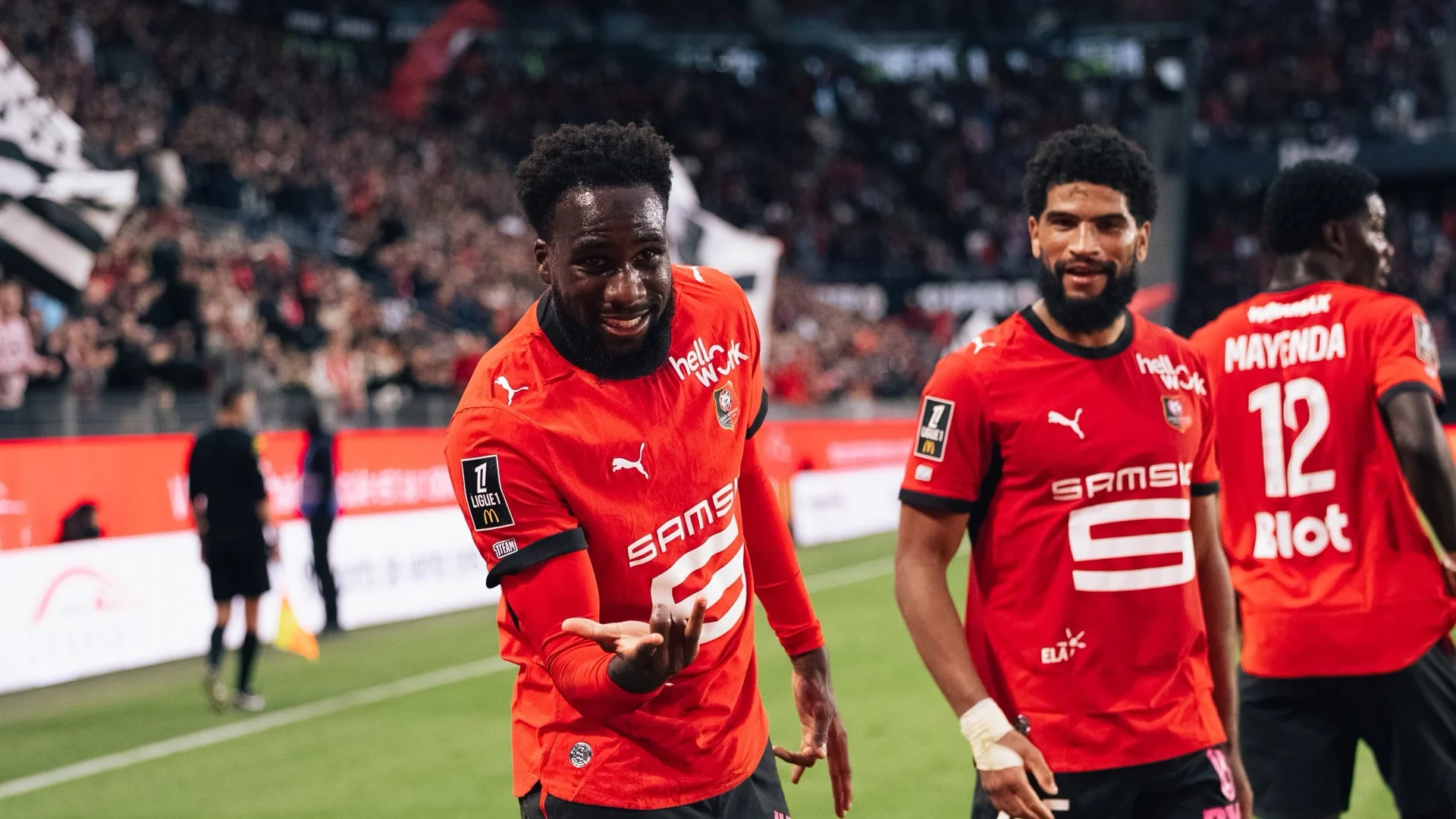 Boulaye Dia in a Rennes red kit celebrating with teammates at Roazhon Park after scoring against Auxerre. Photo: via Maxifoot / match gallery