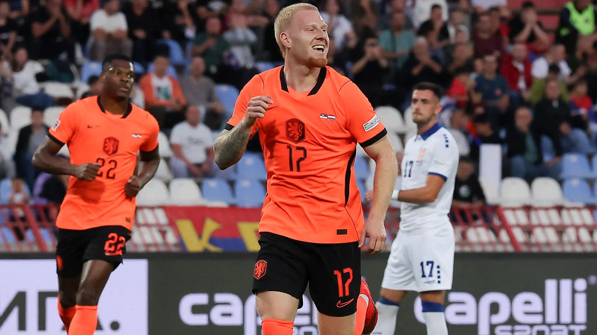 Mexx Meerdink in an orange Netherlands number 17 jersey celebrating after scoring against Serbia in Belgrade