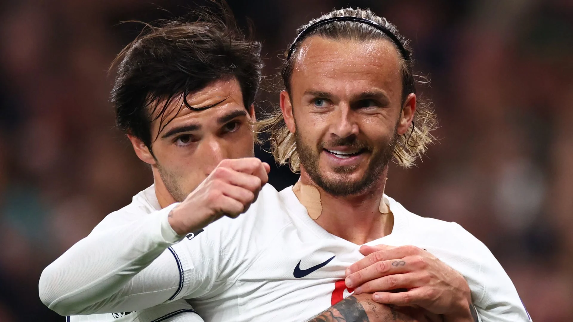 James Maddison smiles as he celebrates his opening goal for Tottenham against Coventry, embraced from behind by a Spurs team-mate, both in Tottenham's white home kit at the Tottenham Hotspur Stadium. Photo: Sky Sports