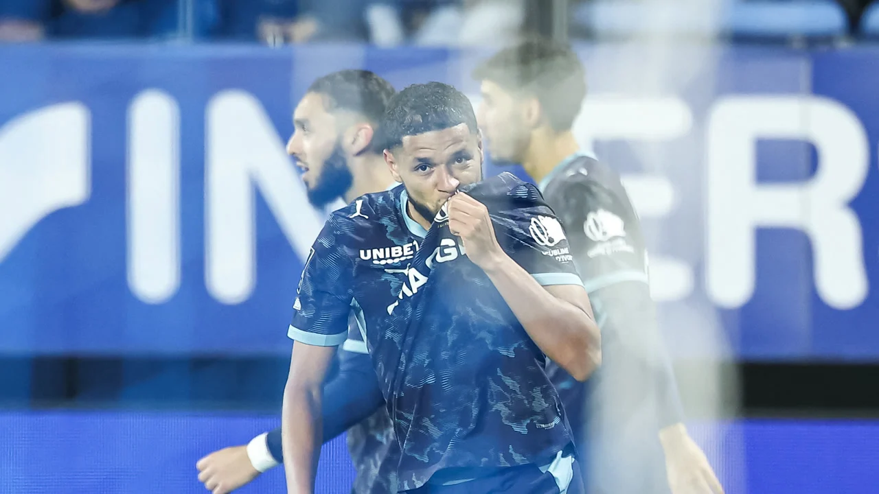 Amine Harit of Marseille celebrates by kissing the club crest on his dark navy away kit after scoring against Troyes at Stade de l'Aube. Photo: Sameer Al-Doumy / AFP