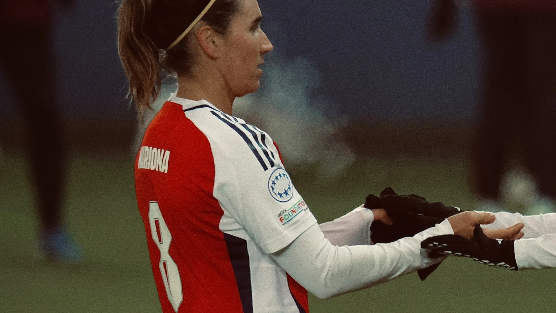 Mariona Caldentey in an Arsenal kit (name MARIONA, number 8) seen in profile on the pitch