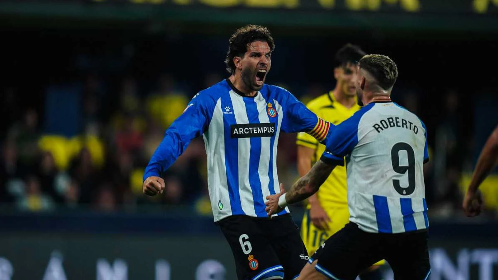 Leandro Cabrera celebrates in Espanyol's blue and white striped kit with Roberto Fernández after scoring against Villarreal at the Estadio de la Cerámica